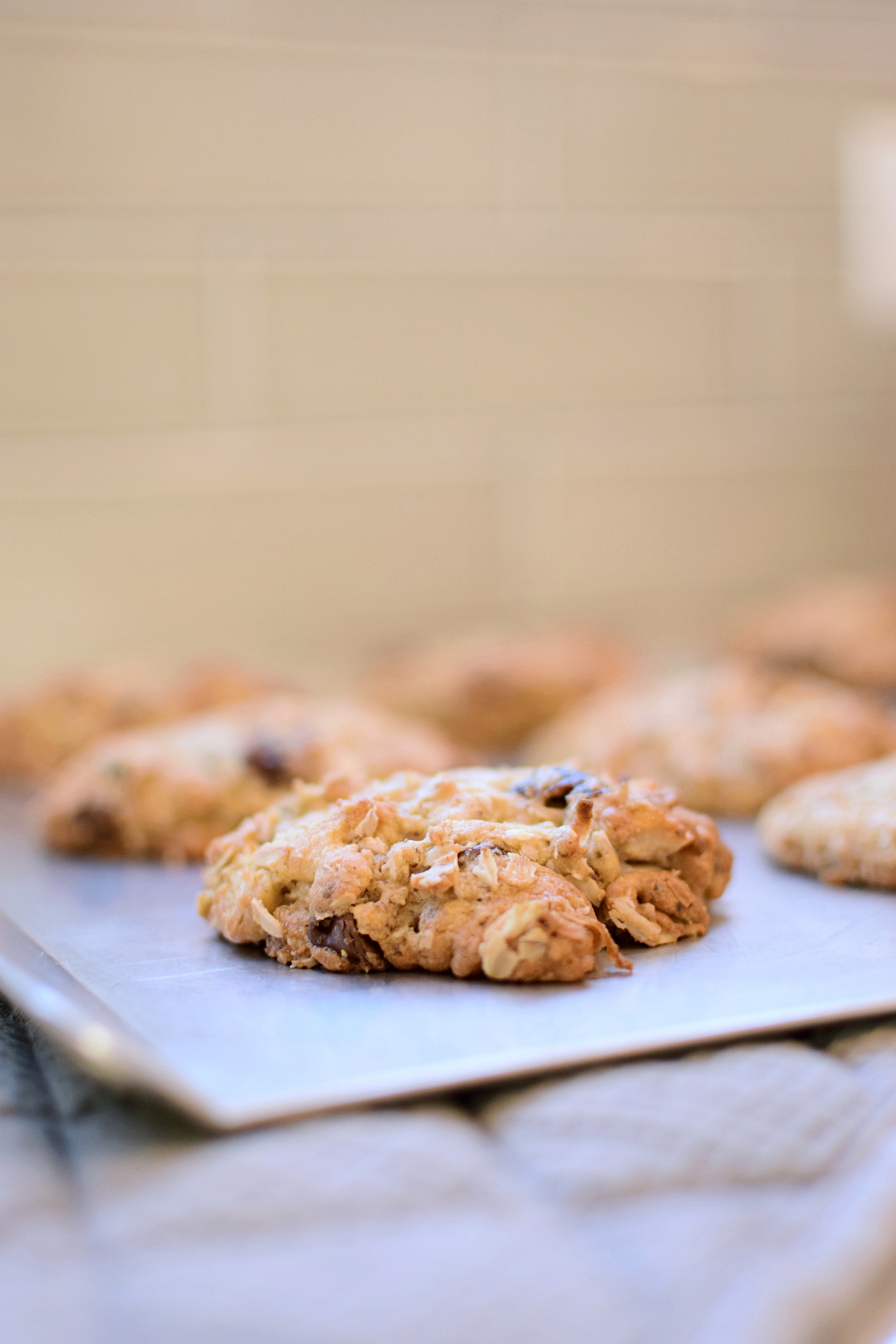 A jumbo loaded oatmeal lactation cookie make with a simple lactation recipe including oatmeal, nuts, flaxseed, brewers yeast, chocolate chips, shredded coconut, and more